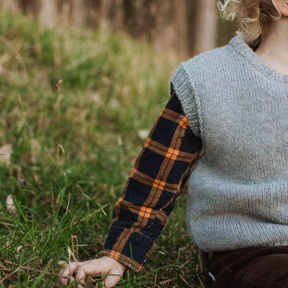 
                      
                        Up close photo of the arm details of a McIvor Hill lambs' wool vest in grey.
                      
                    