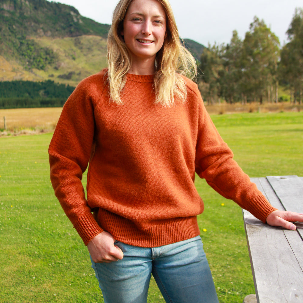 Lady wearing McIvor Hill knitted wool sweater in Rust