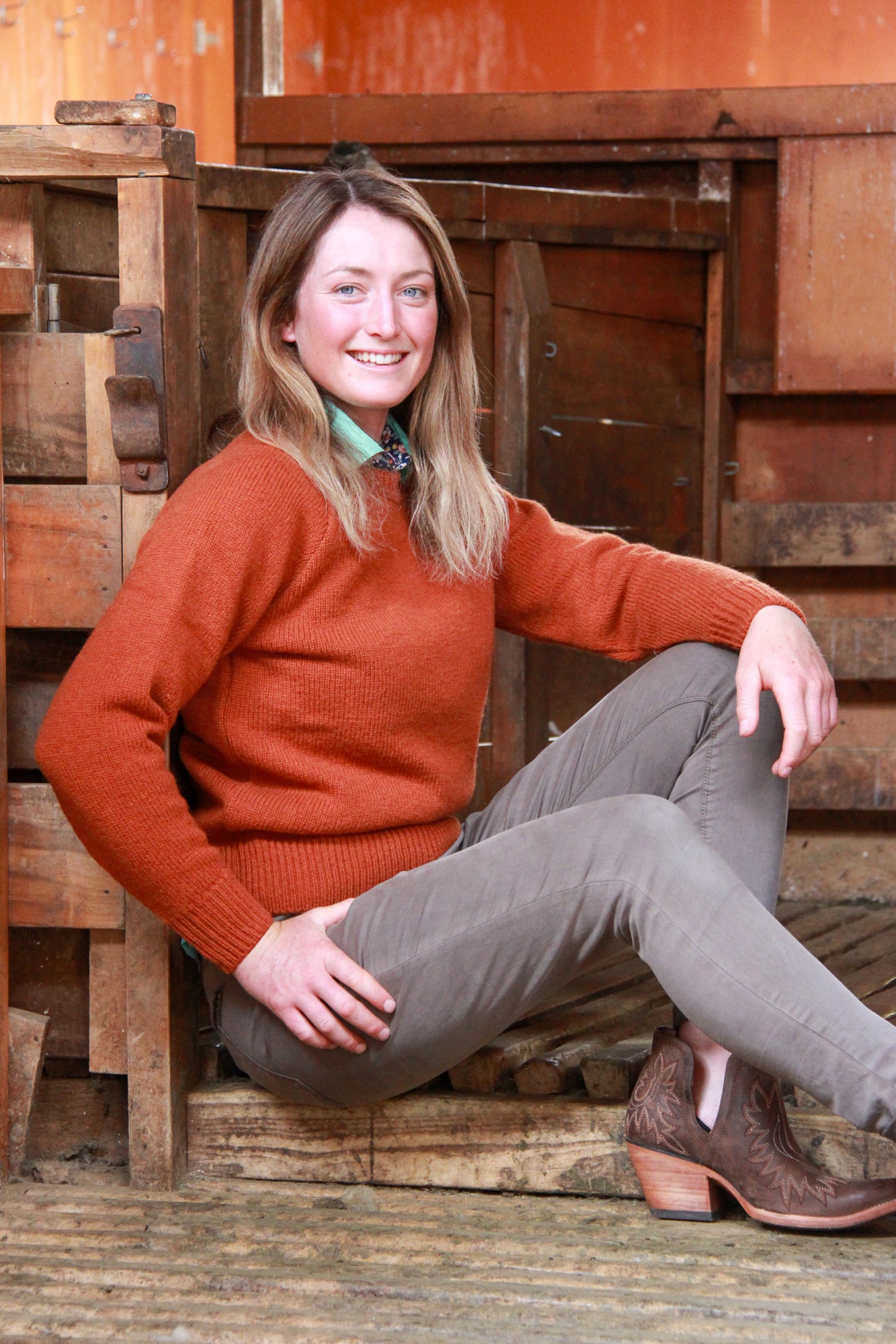 Lady wearing a McIvor Hill Rita wool sweater in rust.